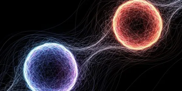 Glowing blue and red spheres suspended in dark space, with faint flowing field lines curving around and between them.