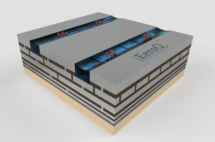 This 3D rendering illustrates a layered system with multiple brick-like structures and blue energy pathways. The setting is a studio with a white background.