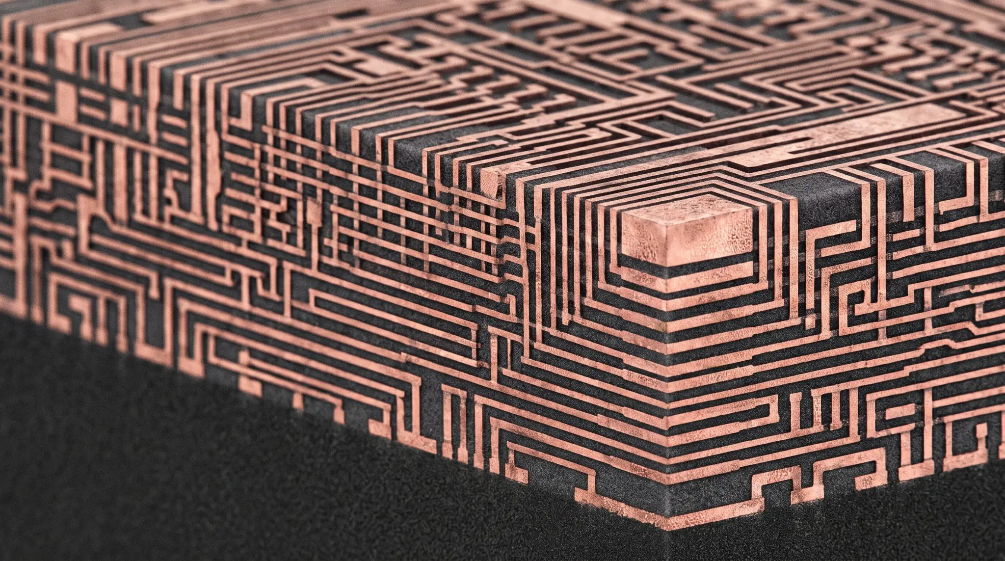 a dark block covered in raised copper traces stepping down in layers like a chip interconnect