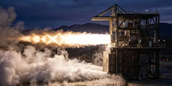A rocket engine firing on a desert test stand