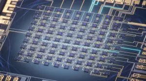This close-up shows a complex microchip circuit board with numerous interconnected components, set against a dark blue background.
