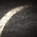A single chalk stroke raking across dark slate