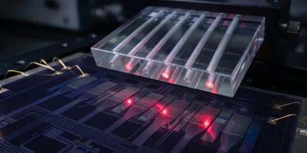 Red light spots under a clear channelled block on a chip