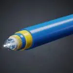 A blue optical fiber cable tip glowing with a beam of transmitted light on a dark background.