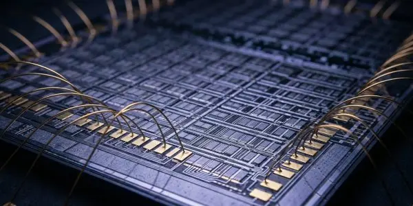 A close-up of a complex microchip with gold connecting wires, set against a dark background with blue highlights.