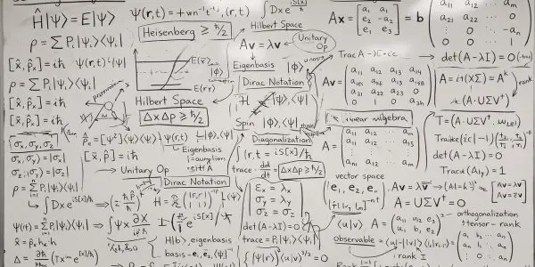 A whiteboard of quantum mechanics worked in dark marker