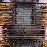This densely packed server rack displays numerous computer components within a data center environment, showcasing a complex network infrastructure.