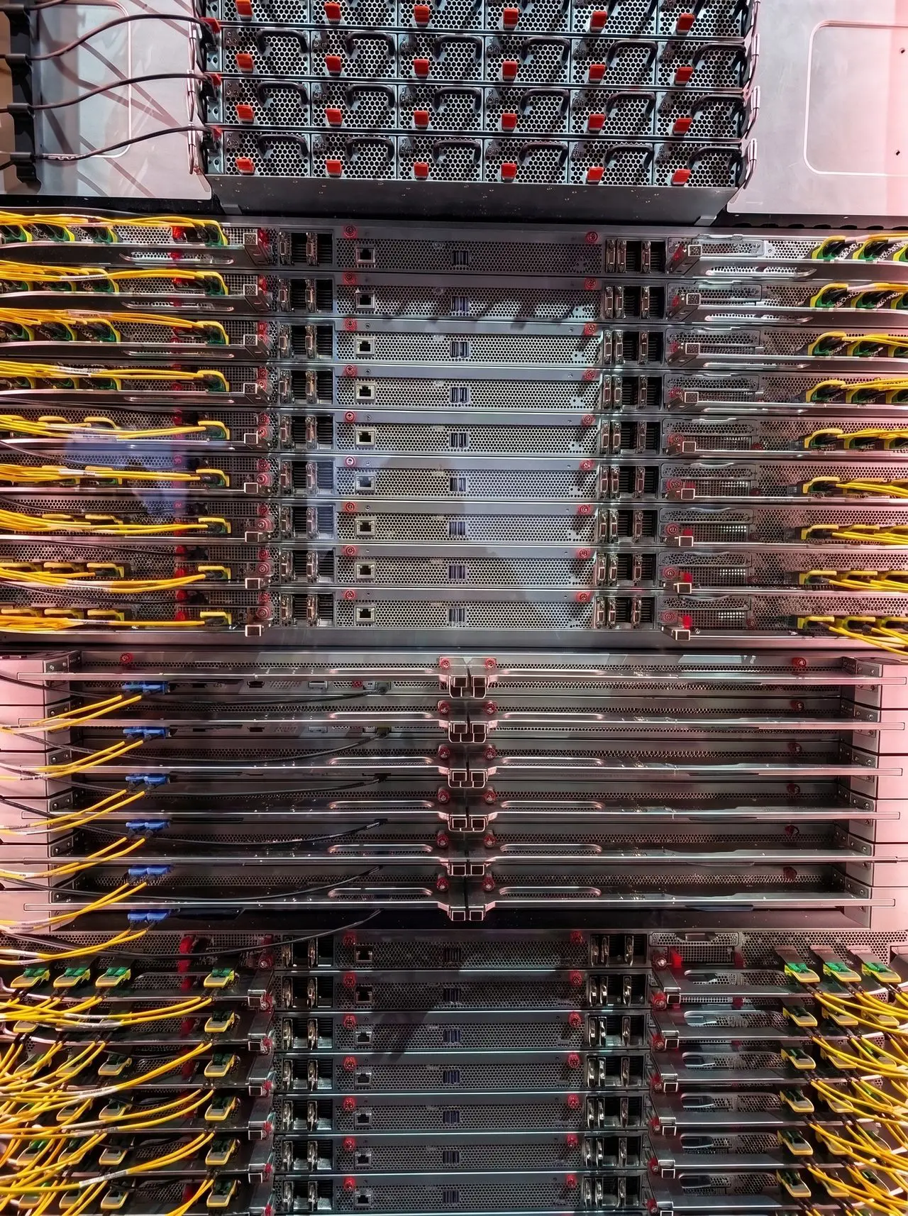 This densely packed server rack displays numerous computer components within a data center environment, showcasing a complex network infrastructure.