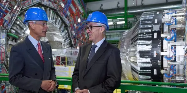 Prince Edward and Mark Thomson talking in front of the CMS detector