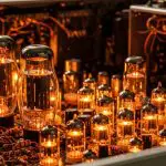 Warmly lit row of vacuum tubes and hand-wiring