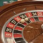 A roulette wheel with the ball settling into a numbered pocket