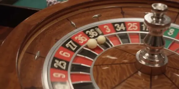 A roulette wheel with the ball settling into a numbered pocket