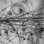 A monochrome photograph displays swirling lines and circular patterns on a textured, dark grey surface, resembling a scientific record