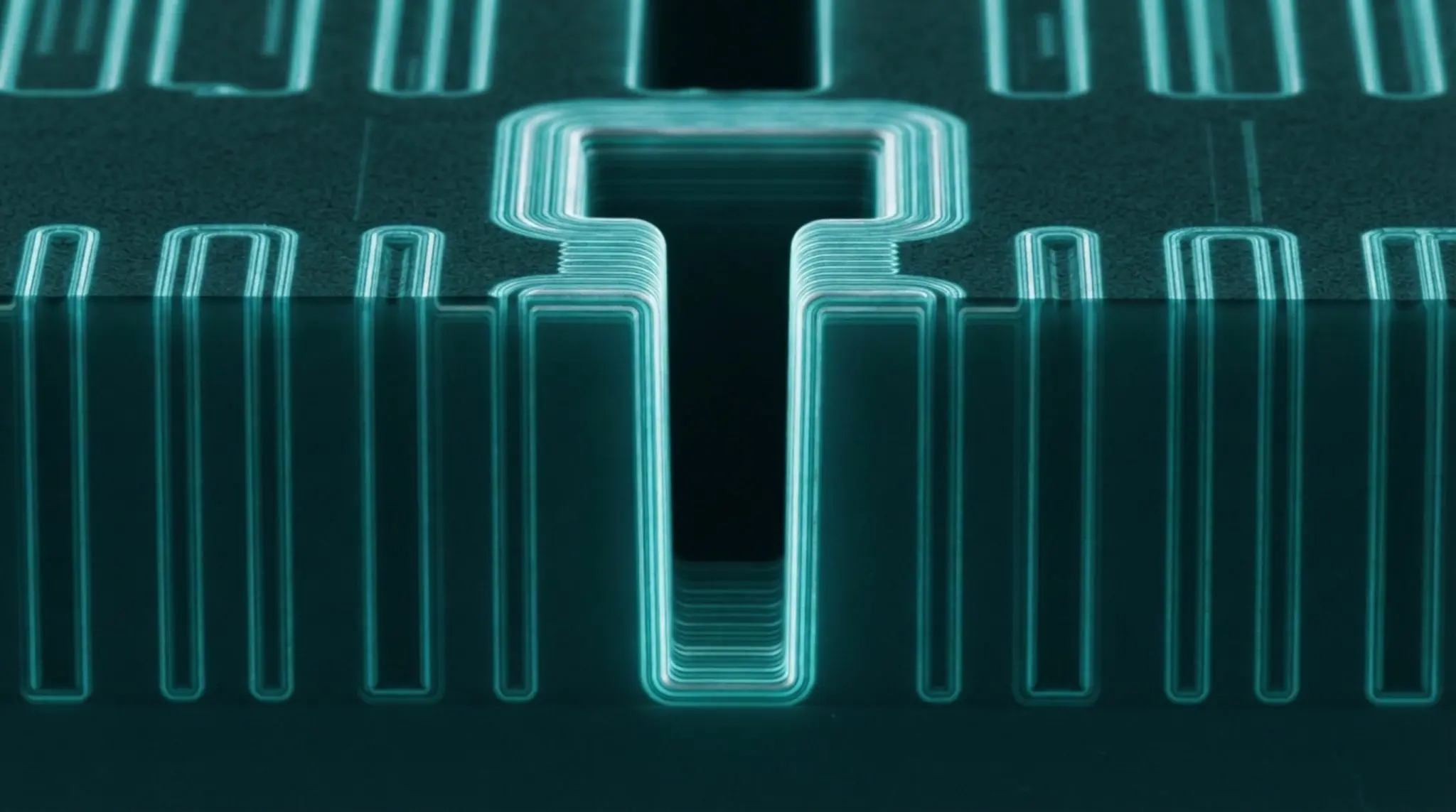 A glowing, teal circuit board with layered metallic pathways is displayed against a dark background
