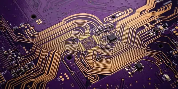 Gold traces fanning out across a circuit board