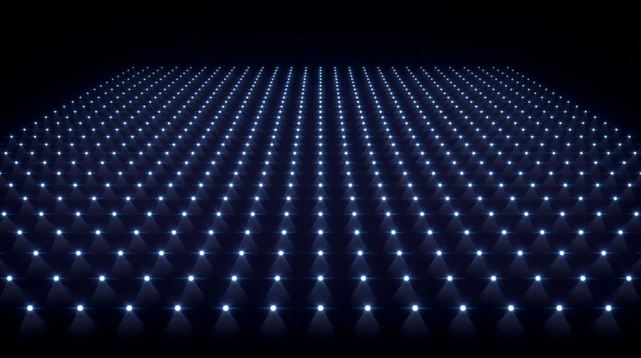 A dark, spherical surface is covered in numerous glowing blue triangular lights, creating a futuristic and abstract design.