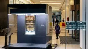 IBM Quantum System One on display in a corporate lobby beside an illuminated IBM logo