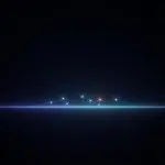 A bright horizontal line of light with several small colored dots connected above it, set on a dark background.