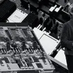 Lisa Su, chair and CEO of AMD, at CES 2026 in a high-contrast editorial portrait with AMD server hardware behind her