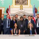 the represenatives from UK and US universities in front of a desk where they have signed the MoU