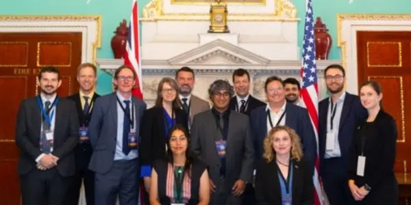 the represenatives from UK and US universities in front of a desk where they have signed the MoU
