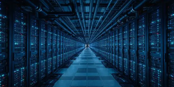 A long blue aisle between two walls of supercomputer racks