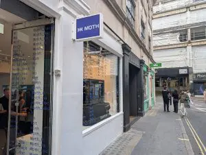 Moth's Soho shopfront at the launch of quantum computers for creatives, with Moth_Hack repeated across the window.