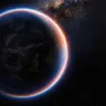 Dark rocky planet with a glowing blue and orange atmospheric rim against stars