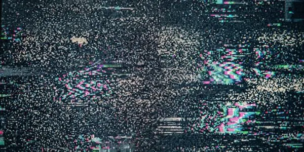 Digital signal breaking up into coloured static, standing for the noise that limits a NISQ quantum computer