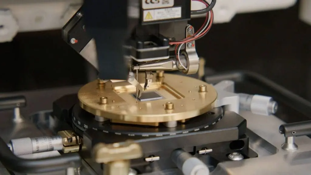 Ocelot is a prototype quantum computing chip developed by AWS to evaluate its quantum error correction architecture. It comprises two silicon microchips, each measuring approximately 1cm², stacked, and electrically connected. The surface of these chips features thin layers of superconducting materials forming quantum circuits.