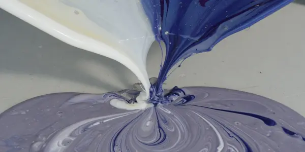 A swirling mix of white, blue and beige fluid converges on a grey surface, resembling a neural network.