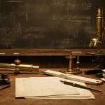 A 1930s physicist's desk with brass instruments and handwritten papers