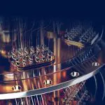 Close-up of a quantum computer’s metallic components with connectors and wires against a dark background