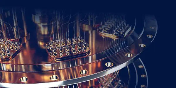 Close-up of a quantum computer’s metallic components with connectors and wires against a dark background