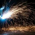 A welder throwing a long spray of sparks