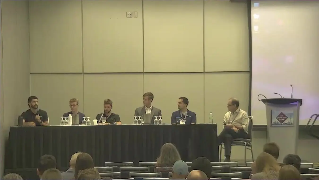 Six panellists on stage at the IEEE Quantum Week panel on scaling quantum processors