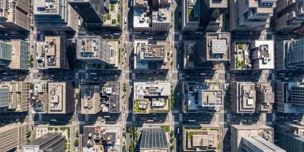 Overhead view of a dense grid of city blocks, rooftops and streets