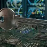 A metallic key rests on a green circuit board, set against a blurred background of server racks and glowing lights.