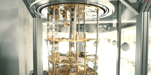 A complex, golden quantum computer is housed within a sleek, modern enclosure, surrounded by silver walls.