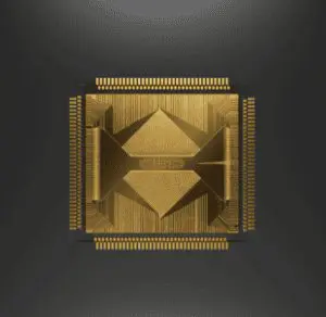A highly detailed golden computer chip is prominently displayed against a dark grey background, showcasing intricate geometric patterns.