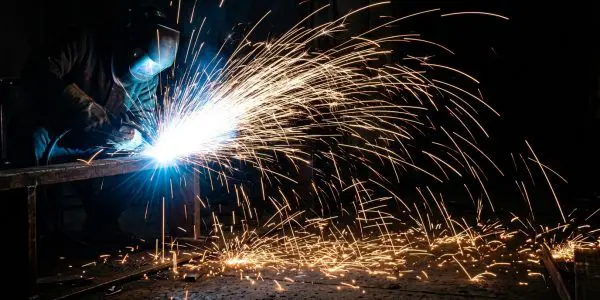 A welder throwing a long spray of sparks