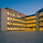 A modern university science building at dusk
