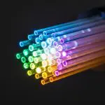 Fan of illuminated fibre strands in rainbow colours