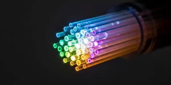 Fan of illuminated fibre strands in rainbow colours
