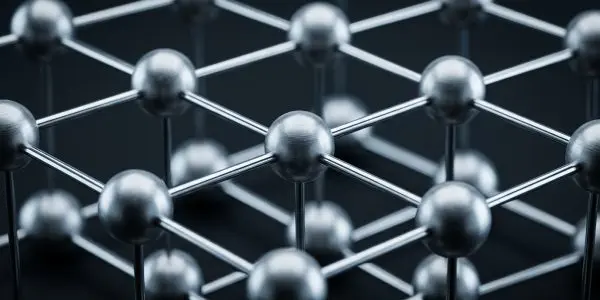 A close-up of a metallic hexagonal lattice structure against a dark background, illuminated with cool, blue-toned lighting.