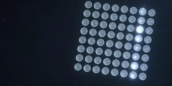 A grid of glowing circular nodes against a dark blue background suggests a computational process or network.