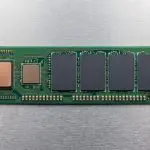 A green solid-state drive module on brushed metal