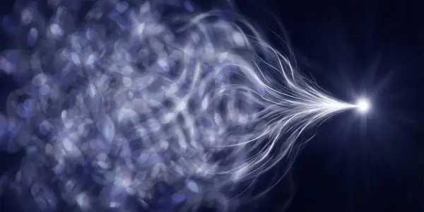 A bright, central star is surrounded by swirling, blurred blue and purple lights extending outwards into the dark space.