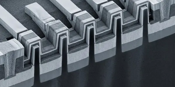 Electron-microscope-style cross-section of FinFET transistor fins wrapped by layered gates