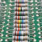 Rows of colour-banded resistors mounted on a green circuit board
